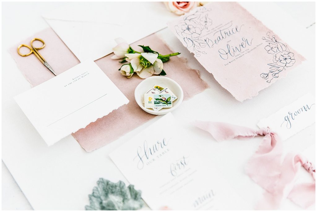 Image of Elegantly styled stationery in pink, blue and white.