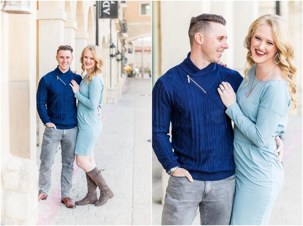 couple in blue outfits posing for their adriatica village engagement photos